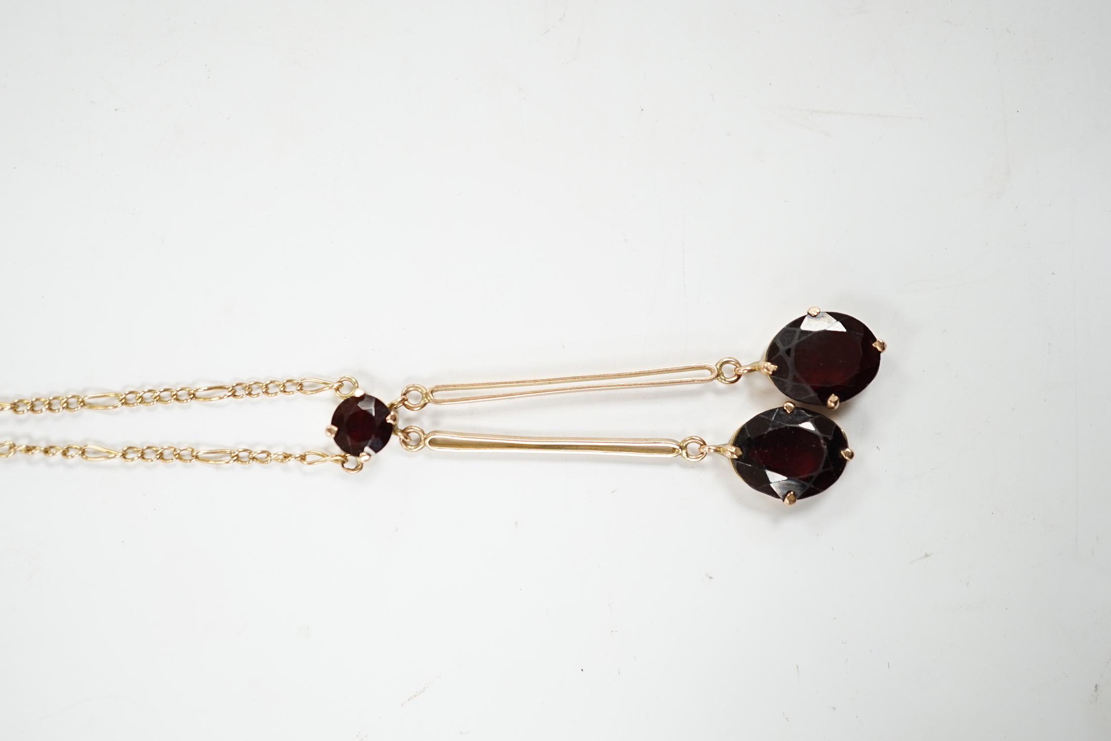 A 9k and three stone garnet set double drop pendant necklace, overall 52cm, gross weight 5.3 grams.